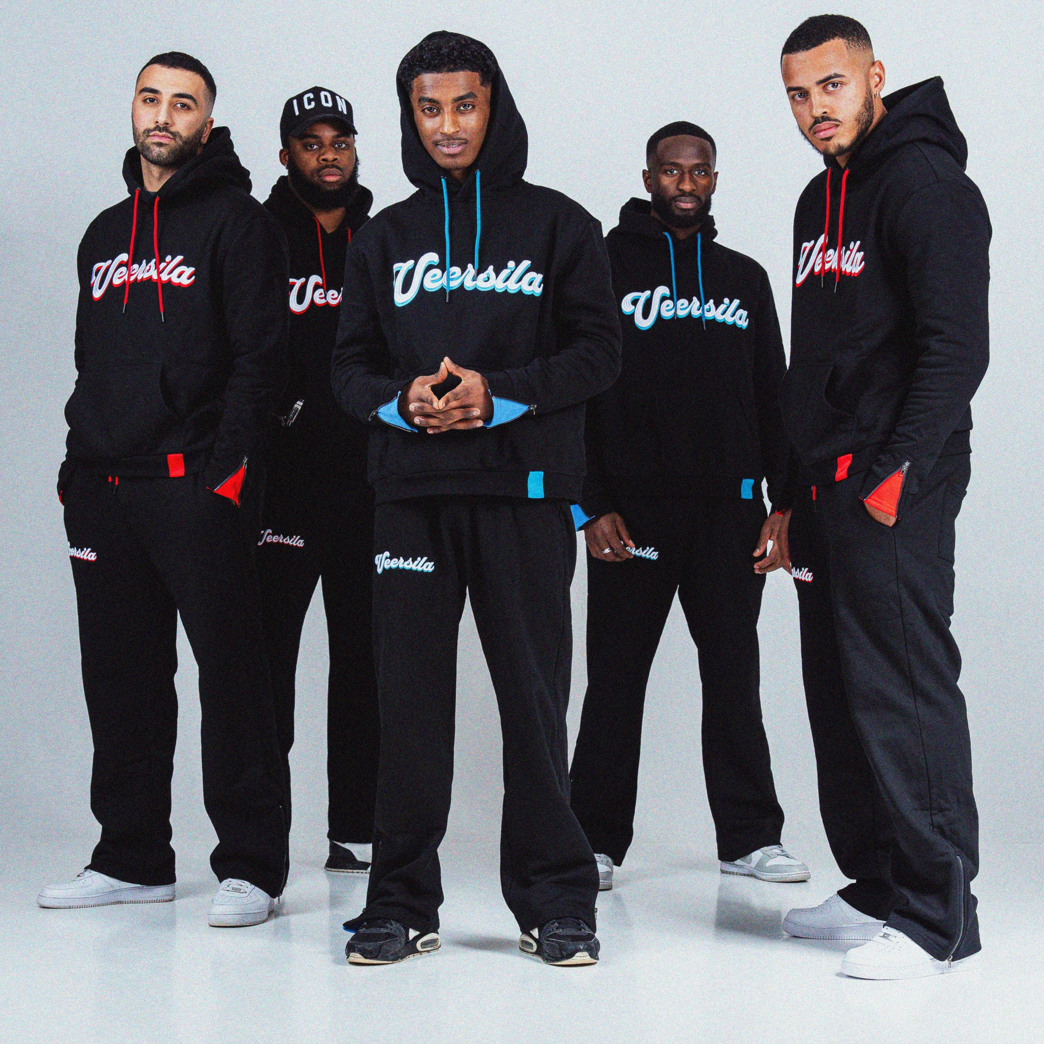 Models wearing the Veersila Tracksuit in red and blue